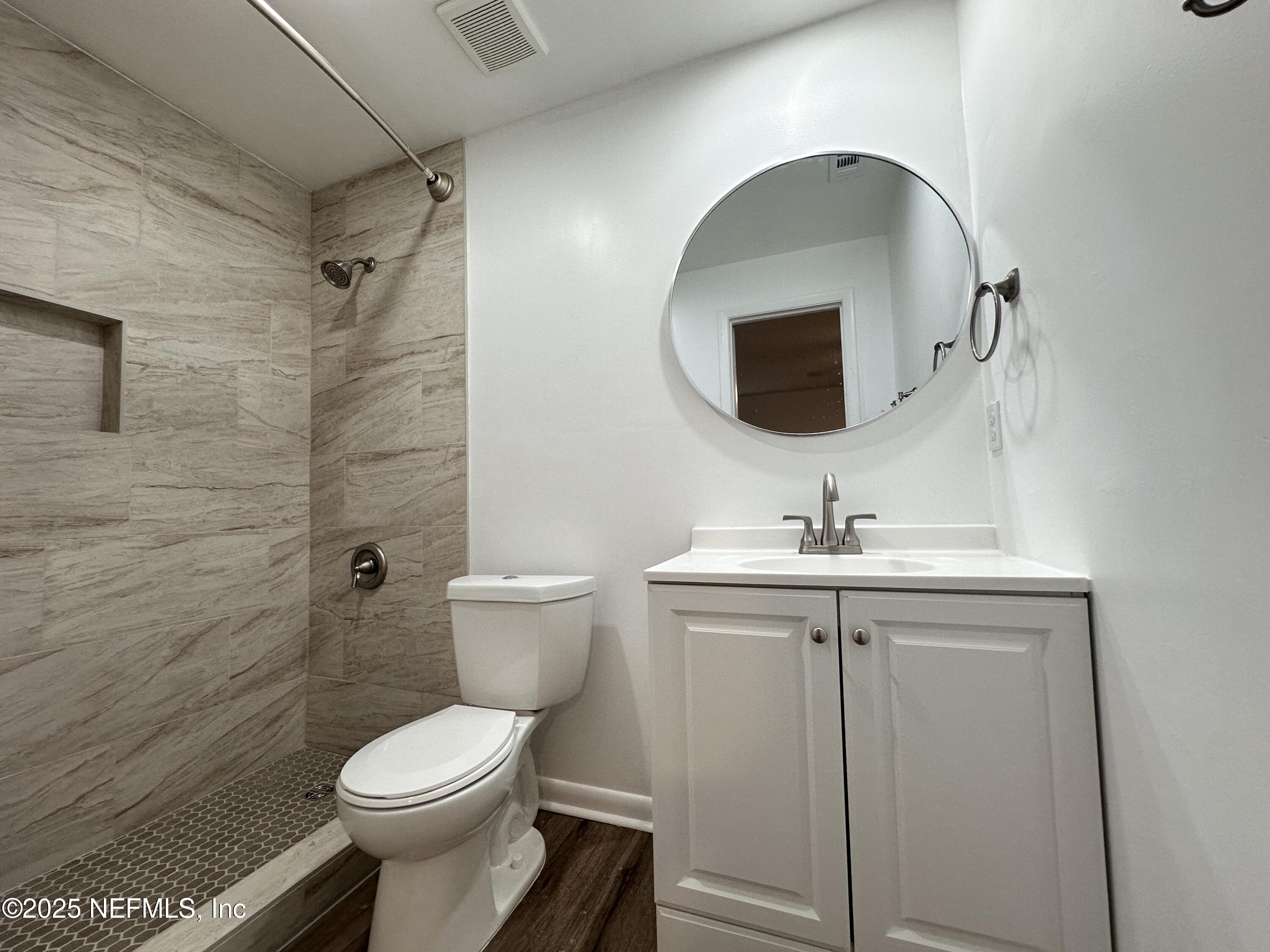 2538 Green Spring Drive Jacksonville, FL 32246 - Photo 9 of 15 a bathroom with a toilet sink and mirror