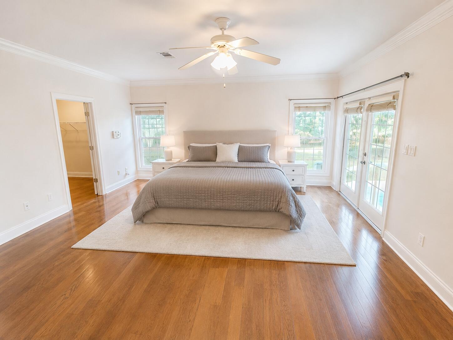 147 Dover Lane Freeport, FL 32439 - Photo 5 of 27 a bedroom with a large bed and a chandelier