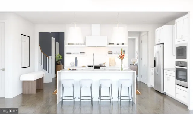 a kitchen with stainless steel appliances kitchen island granite countertop a refrigerator and a stove