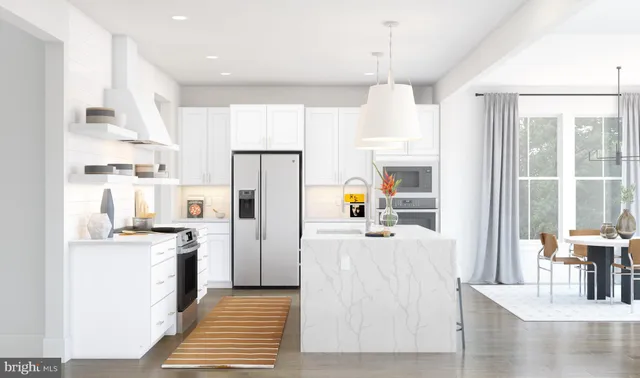 a kitchen with stainless steel appliances kitchen island granite countertop a refrigerator and a stove top oven