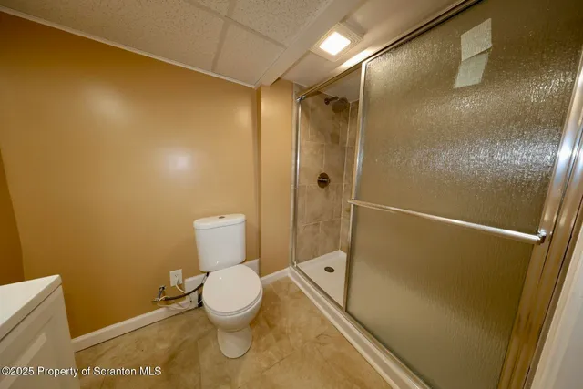a bathroom with a toilet and a shower
