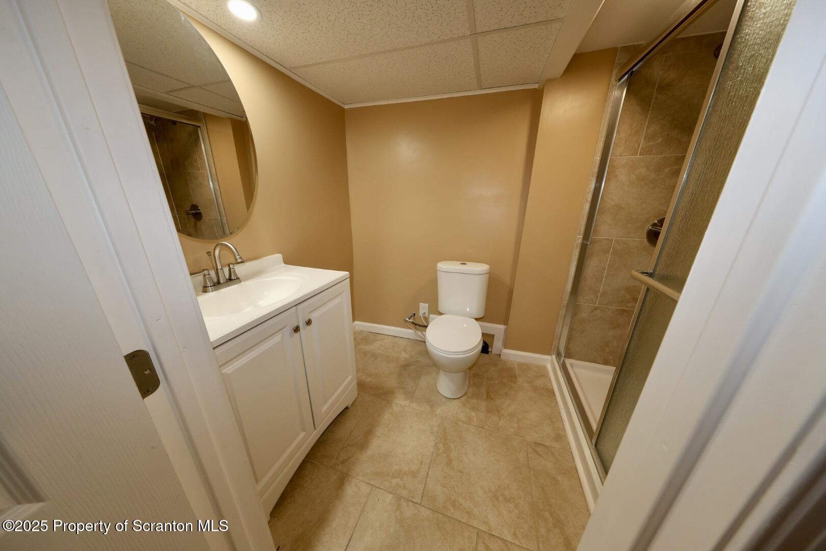 322 1st Street Olyphant, PA 18447 - Photo 6 of 13 a bathroom with a sink a toilet a mirror and vanity