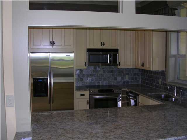 32 Grande Pointe Circle Inlet Beach, FL 32461 - Photo 3 of 16 a kitchen with stainless steel appliances a refrigerator a stove and cabinets