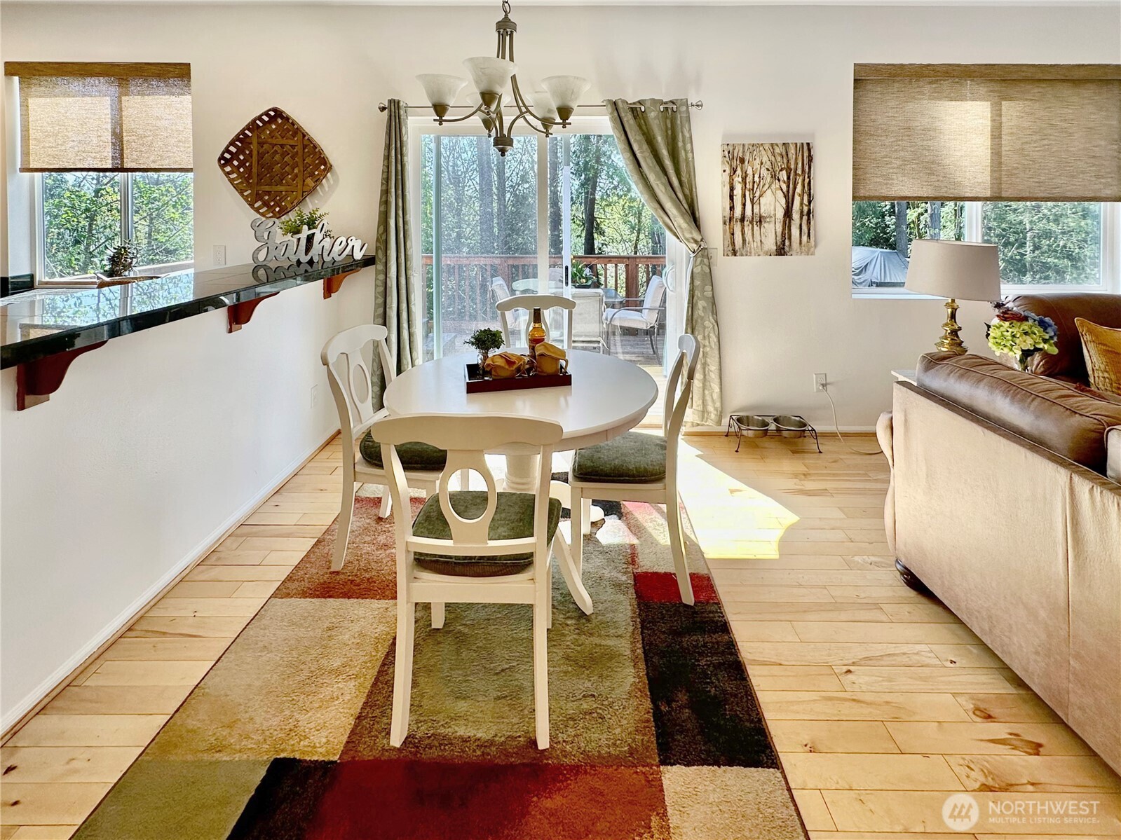 1348 Ebbets Drive Tumwater, WA 98512 - Photo 14 of 37 a view of a dining room with furniture a rug and wooden floor