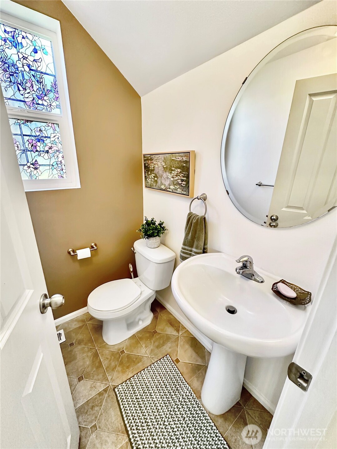 1348 Ebbets Drive Tumwater, WA 98512 - Photo 21 of 37 a bathroom with a toilet sink and mirror