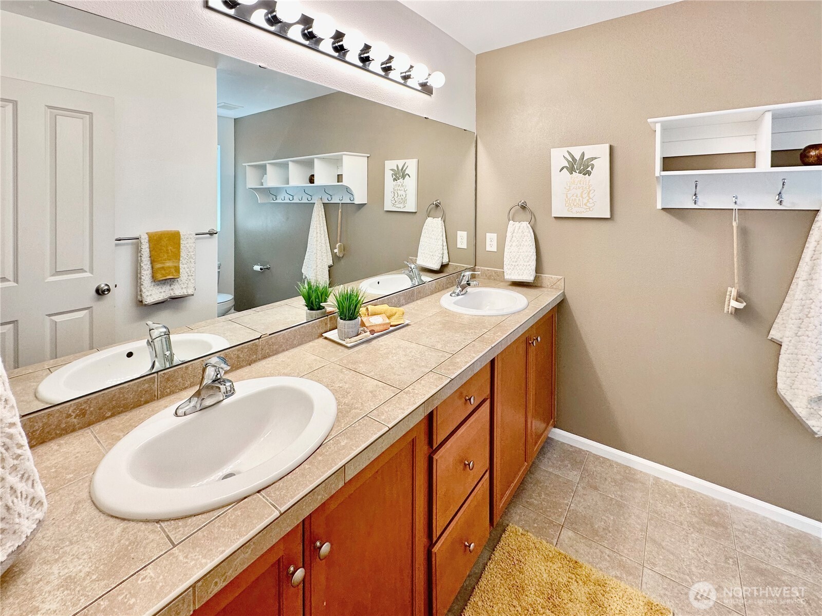 1348 Ebbets Drive Tumwater, WA 98512 - Photo 26 of 37 a bathroom with a double vanity sink and a mirror