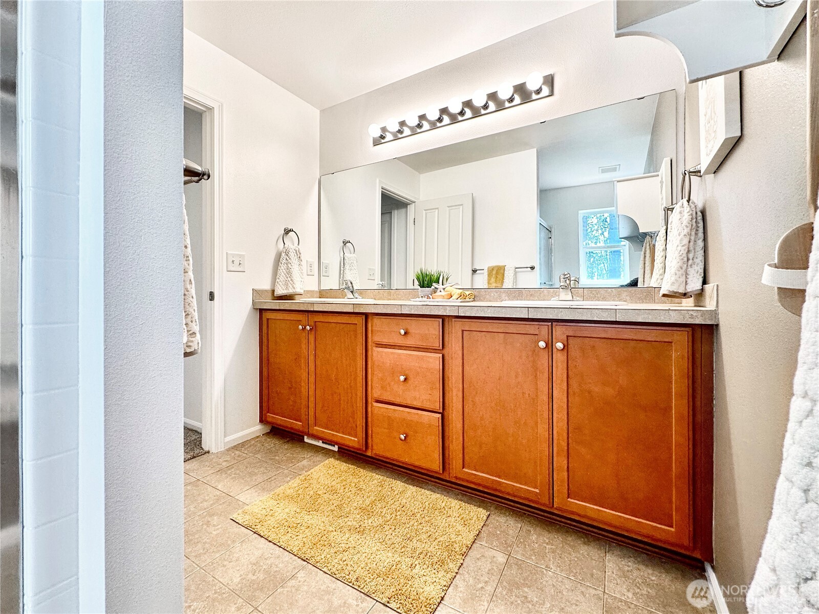 1348 Ebbets Drive Tumwater, WA 98512 - Photo 27 of 37 a bathroom with a granite countertop sink mirror and cabinets