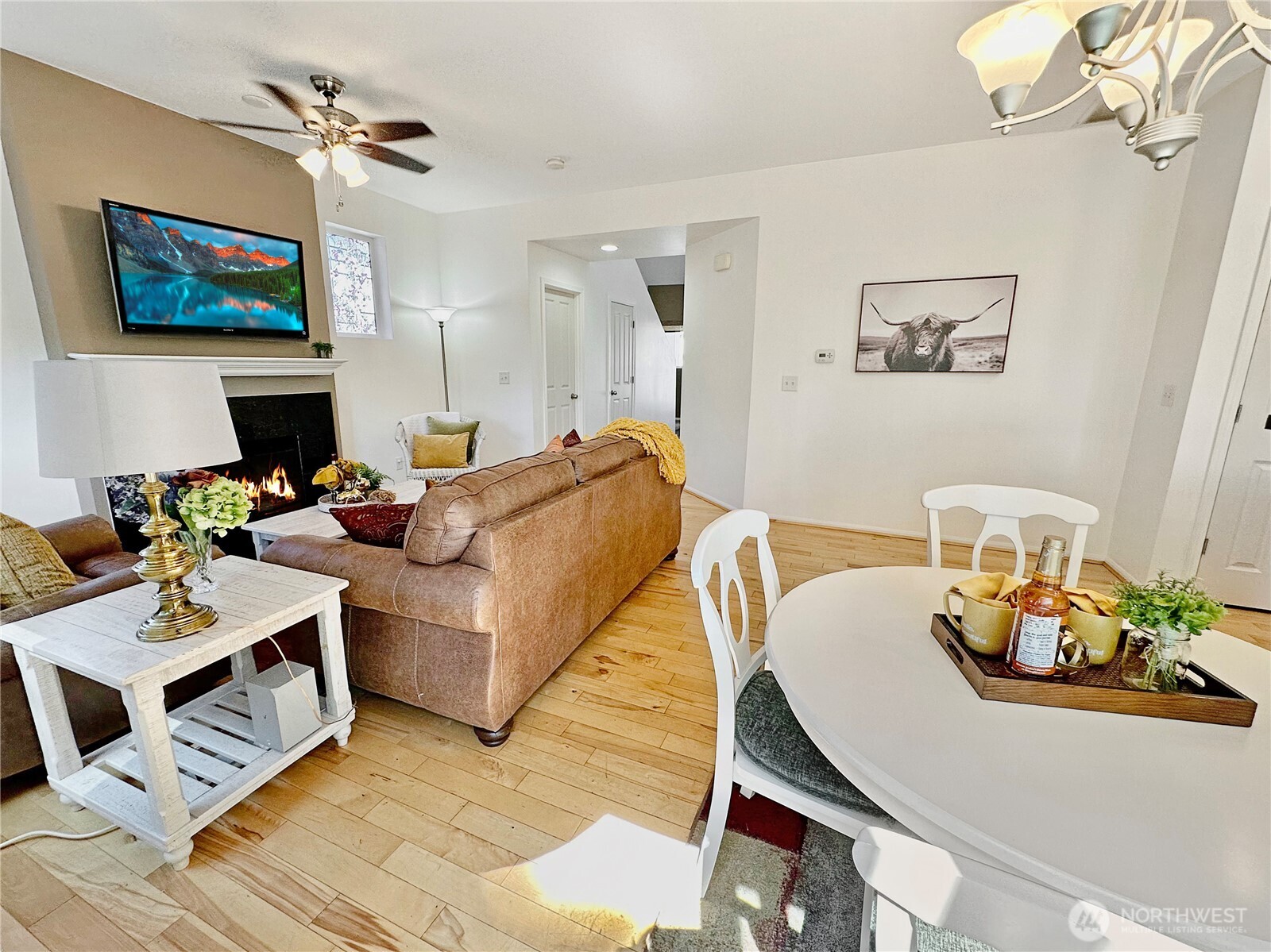 1348 Ebbets Drive Tumwater, WA 98512 - Photo 8 of 37 a living room with furniture a fireplace and a flat screen tv