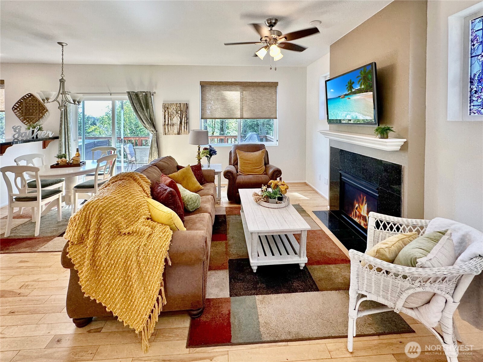 1348 Ebbets Drive Tumwater, WA 98512 - Photo 9 of 37 a living room with furniture a fireplace and a flat screen tv