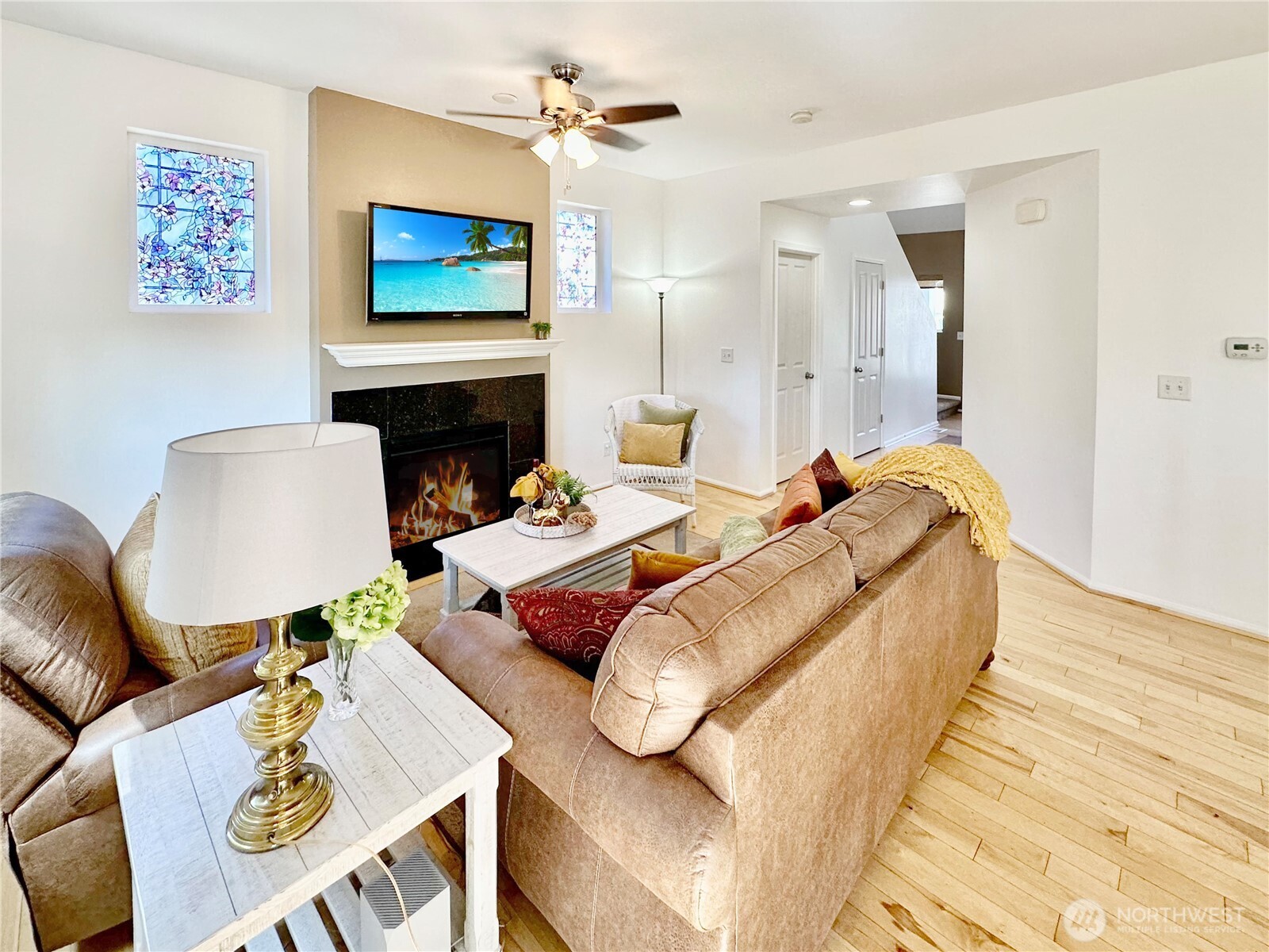 1348 Ebbets Drive Tumwater, WA 98512 - Photo 10 of 37 a bedroom with a bed a couch and a flat screen tv