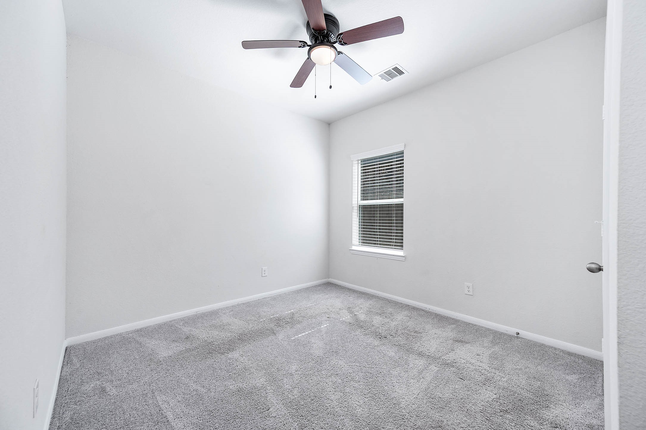 3611 Prairie Rose Trail Angleton, TX 77515 - Photo 15 of 25 an empty room with a window and a fan