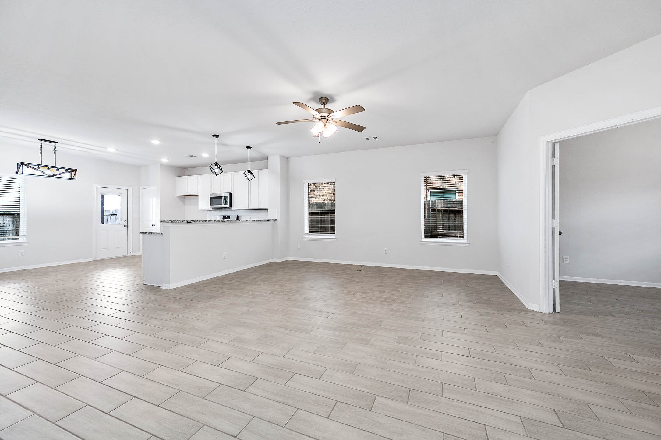 3611 Prairie Rose Trail Angleton, TX 77515 - Photo 5 of 25 a view of a kitchen with furniture and a ceiling fan