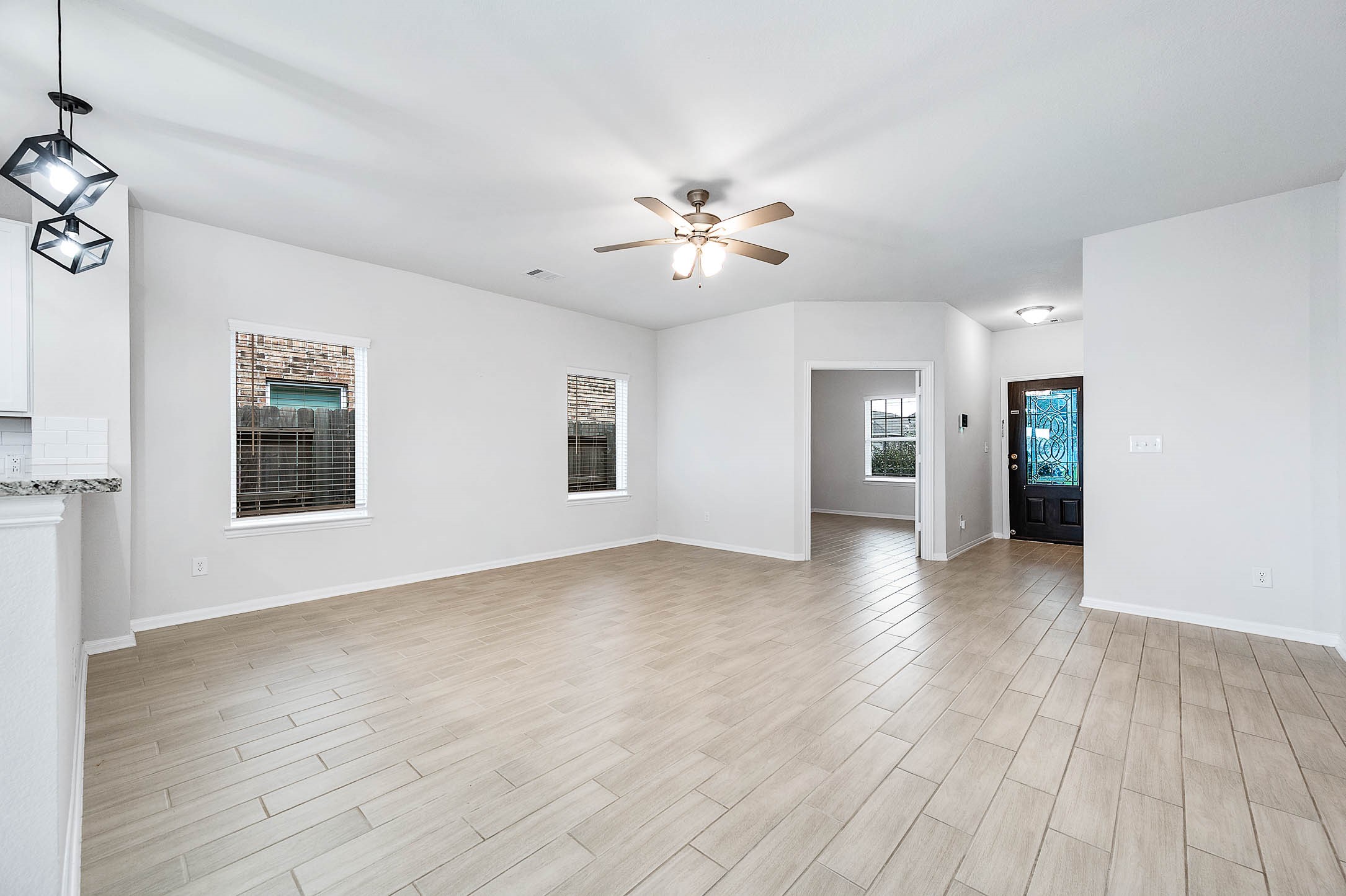 3611 Prairie Rose Trail Angleton, TX 77515 - Photo 6 of 25 wooden floor in an empty room with a window