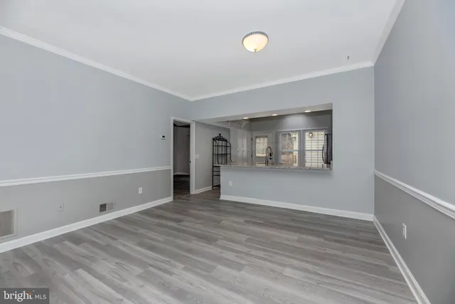 a view of a kitchen with kitchen island and stainless steel appliances