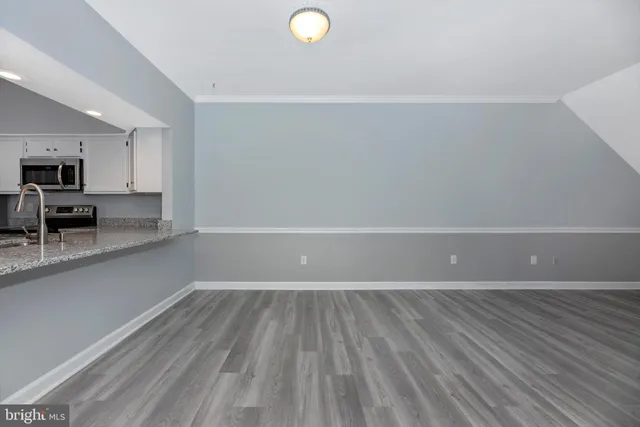 a kitchen with stainless steel appliances granite countertop a refrigerator sink and stove