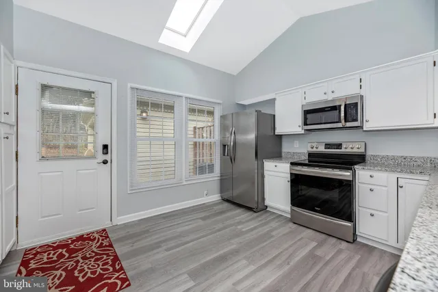 a bedroom with a large bed and a couch