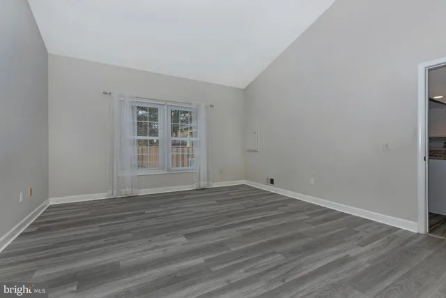 a bathroom with a granite countertop sink a toilet and a mirror