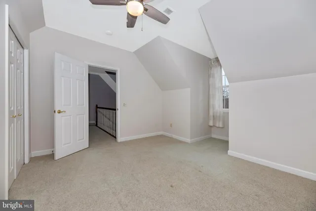 a view of a house with wooden fence
