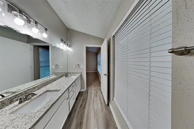 a bathroom with a double vanity sink and mirror