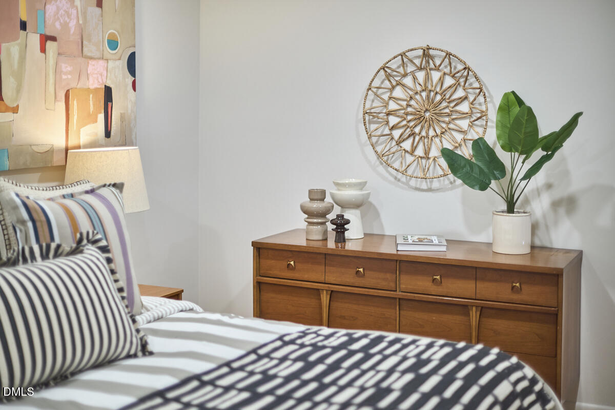 2613 McNeil Street, Unit B Raleigh, NC 27608 - Photo 24 of 31 a bedroom with a bed and a potted plant