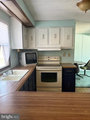 a kitchen with a stove and a sink