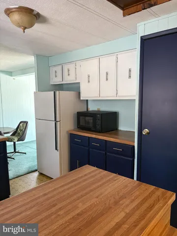 a kitchen with a refrigerator and a stove