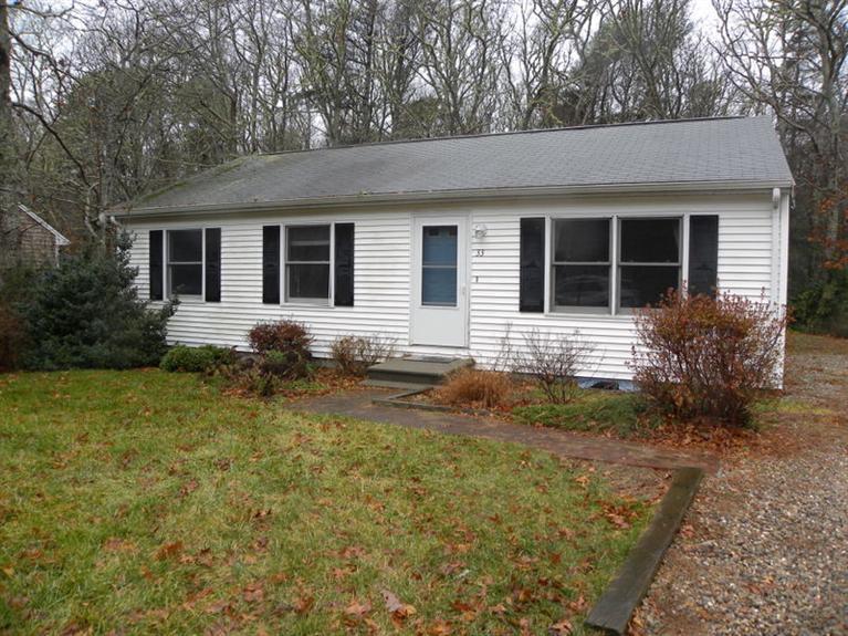 33 Uncle Edwards Road Mashpee, MA 02649 - Photo 1 of 5 front view of house with a yard