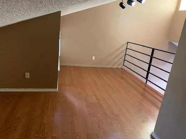 a view of a room with wooden floor