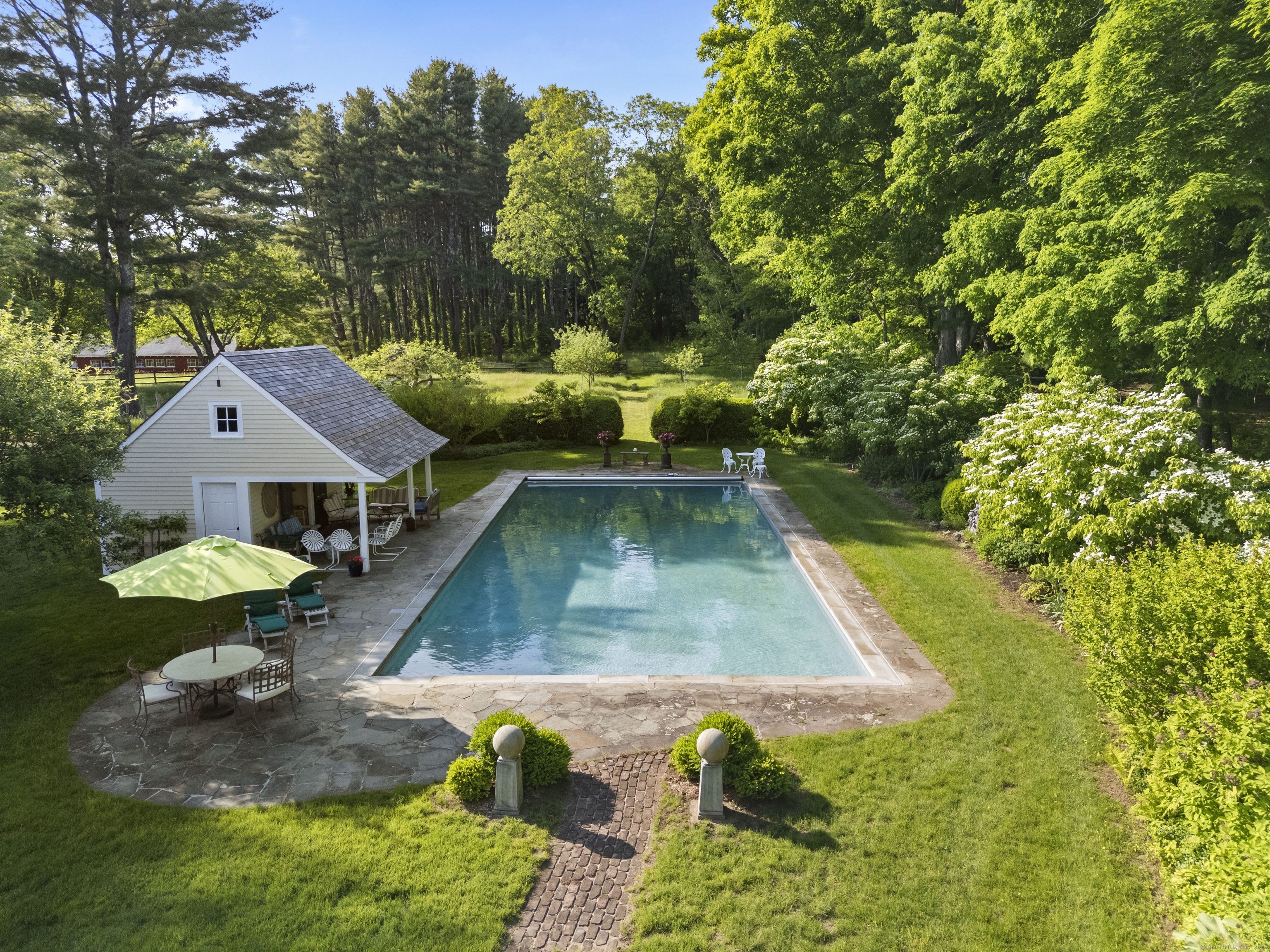 53-1 Selden Road Lyme, CT 06371 - Photo 27 of 40 Enjoy swimming laps in the inground gunite pool with retractable cover then relax poolside in the cabana with full bath and bar area.