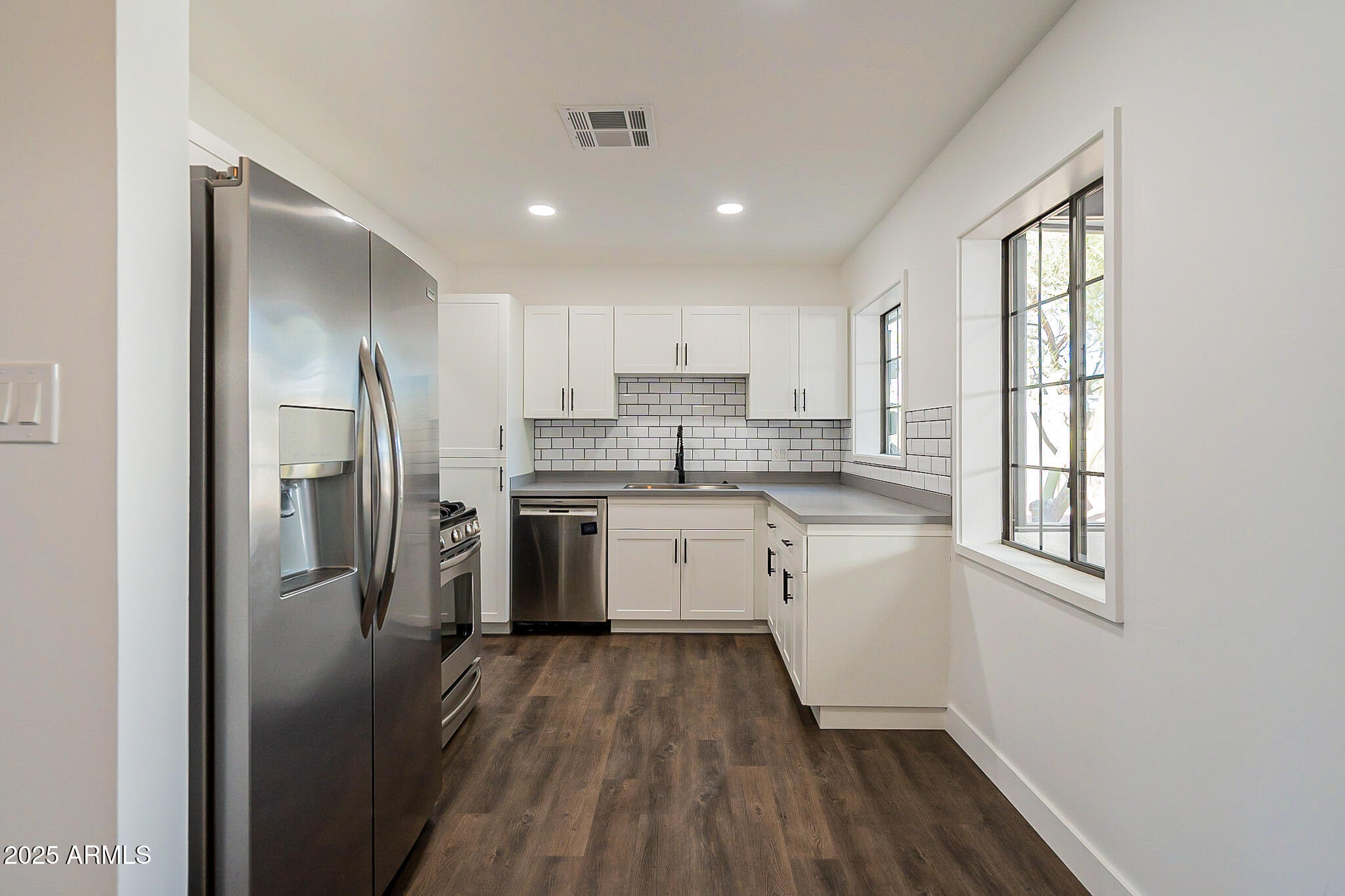 1316 East Lemon Street Tempe, AZ 85281 - Photo 11 of 43 a kitchen with a white cabinets and wooden floor