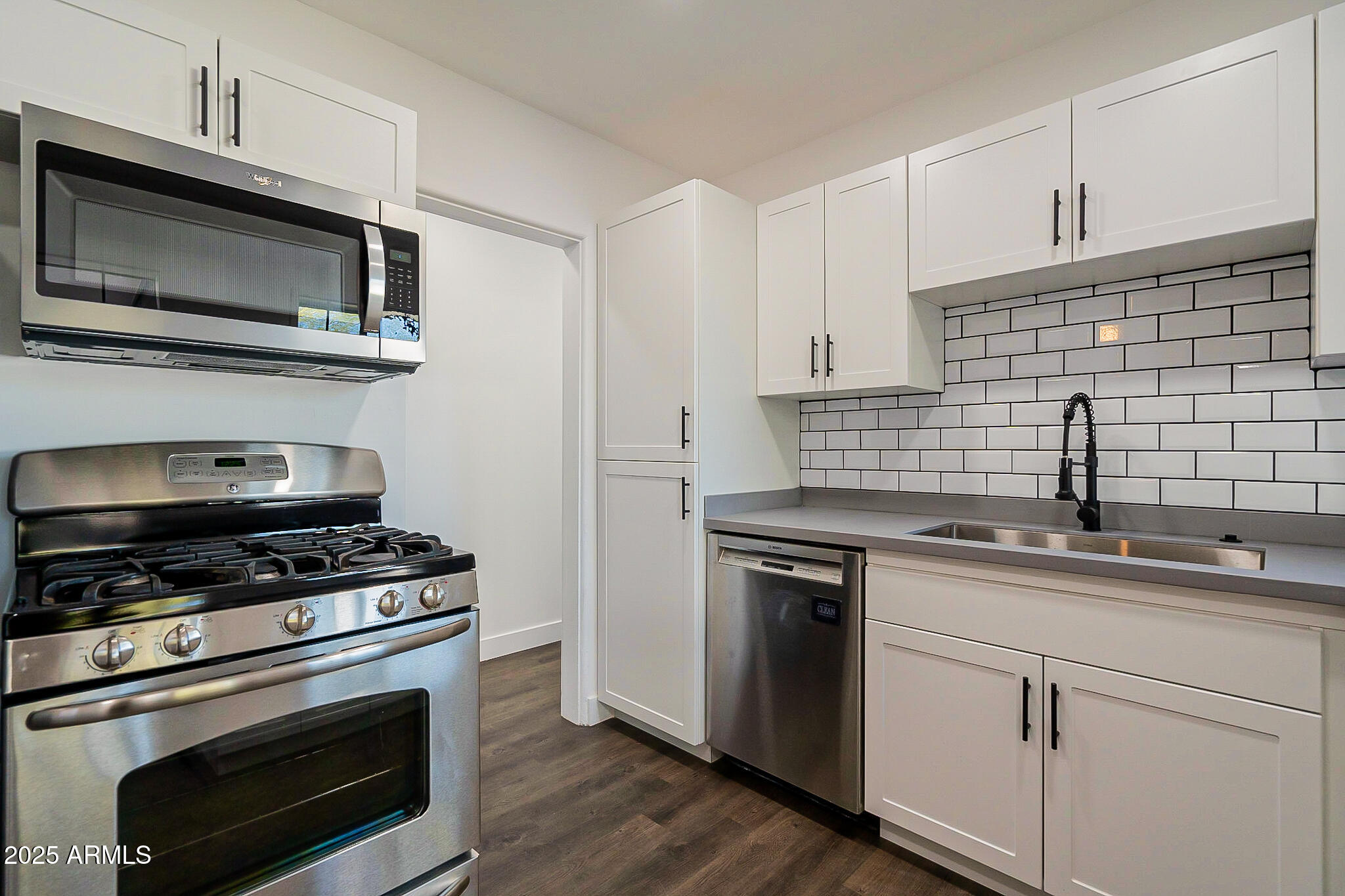 1316 East Lemon Street Tempe, AZ 85281 - Photo 13 of 43 a kitchen with cabinets stainless steel appliances a sink and a stove