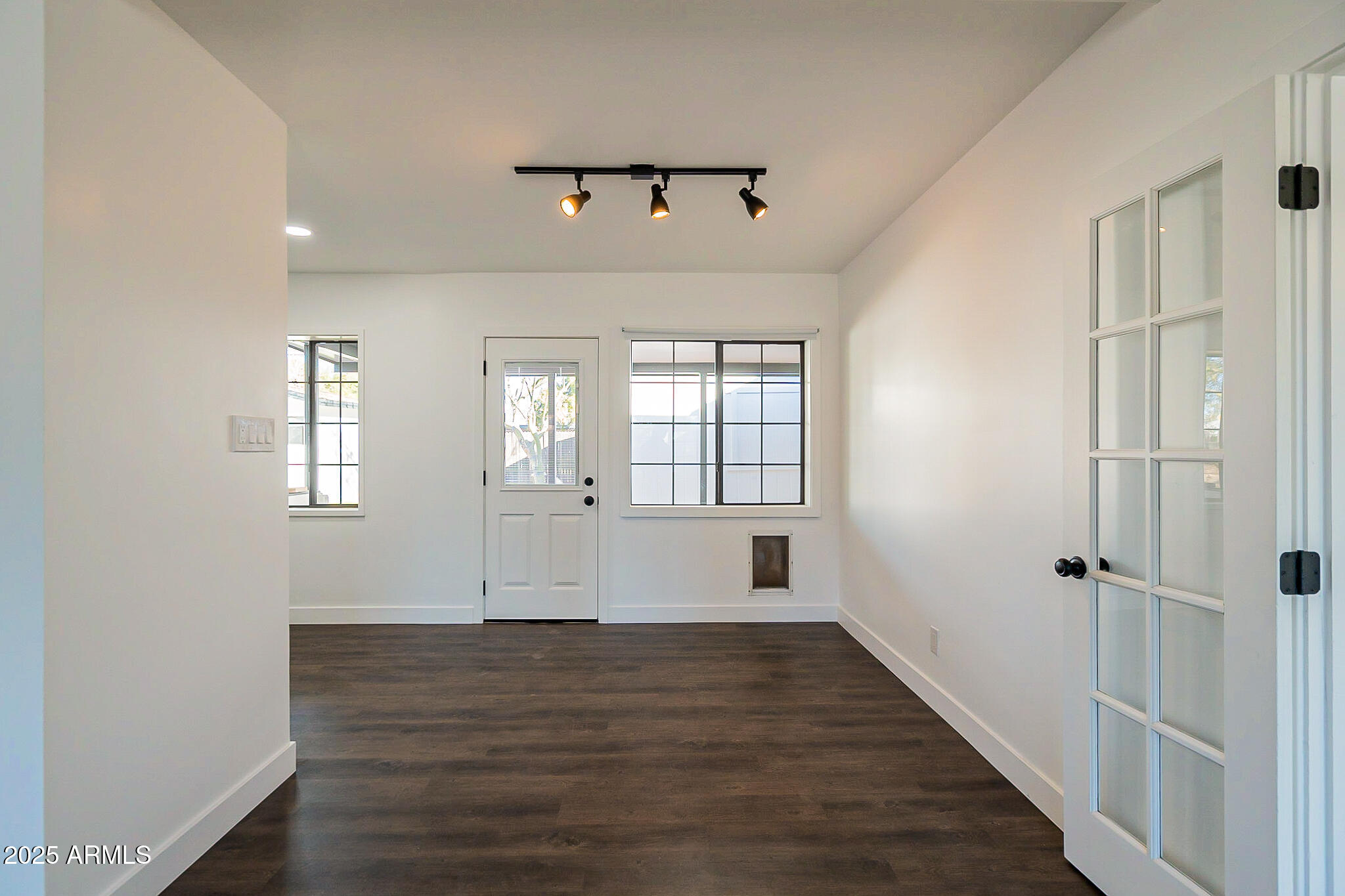 1316 East Lemon Street Tempe, AZ 85281 - Photo 17 of 43 a view of an empty room with wooden floor and a window