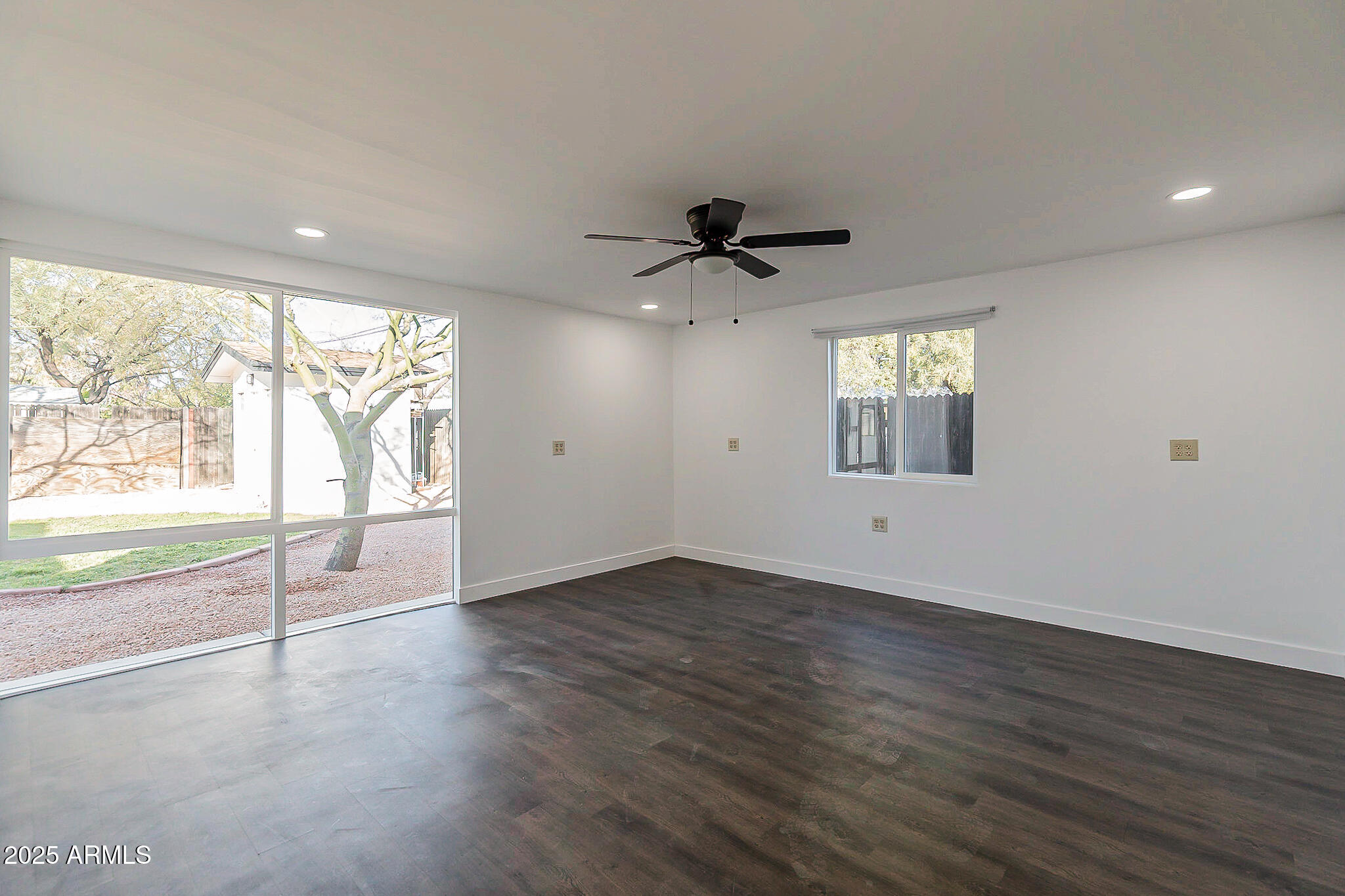 1316 East Lemon Street Tempe, AZ 85281 - Photo 19 of 43 a view of an empty room with a window and wooden floor