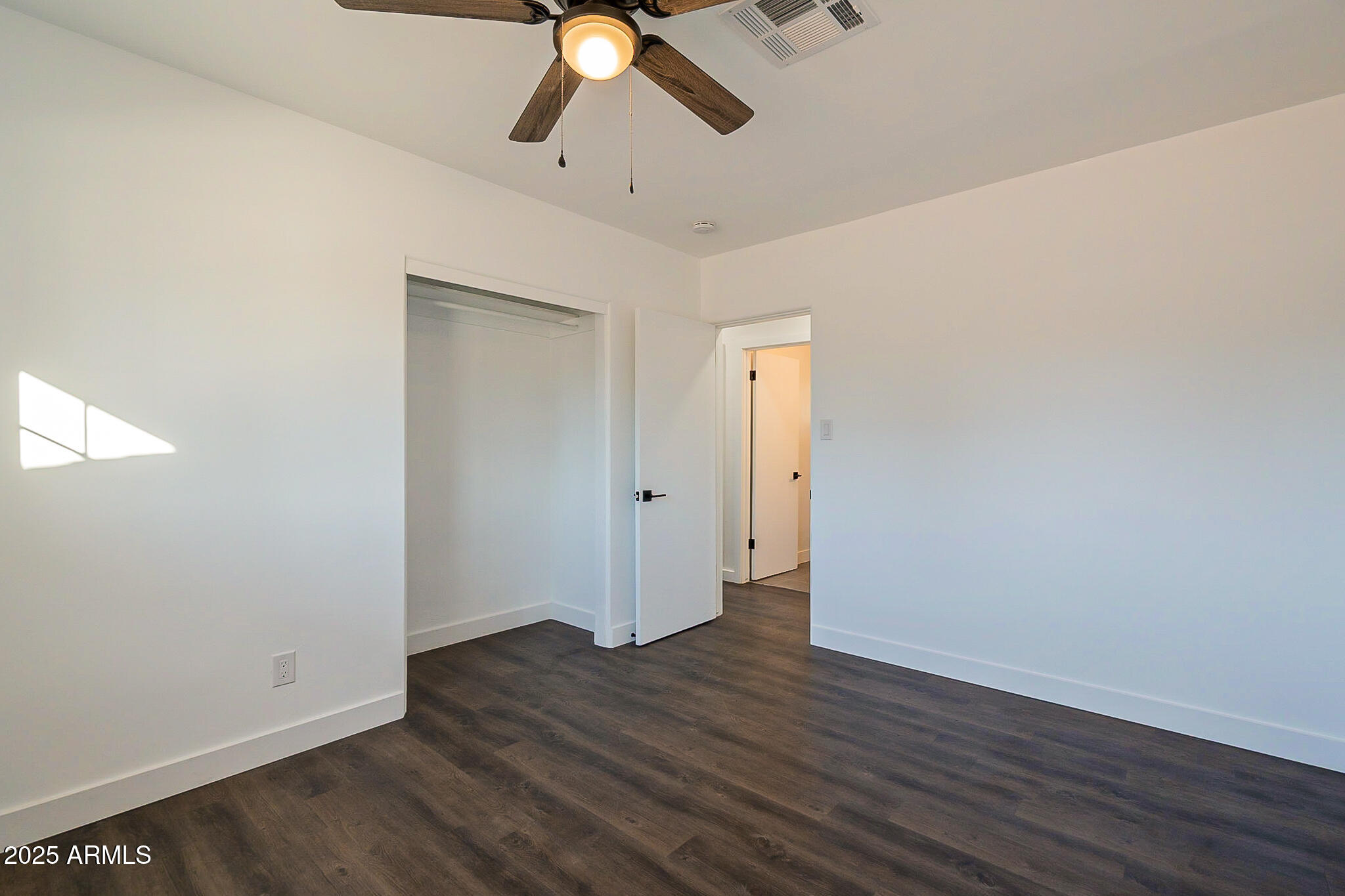 1316 East Lemon Street Tempe, AZ 85281 - Photo 25 of 43 an empty room with wooden floor fan and windows