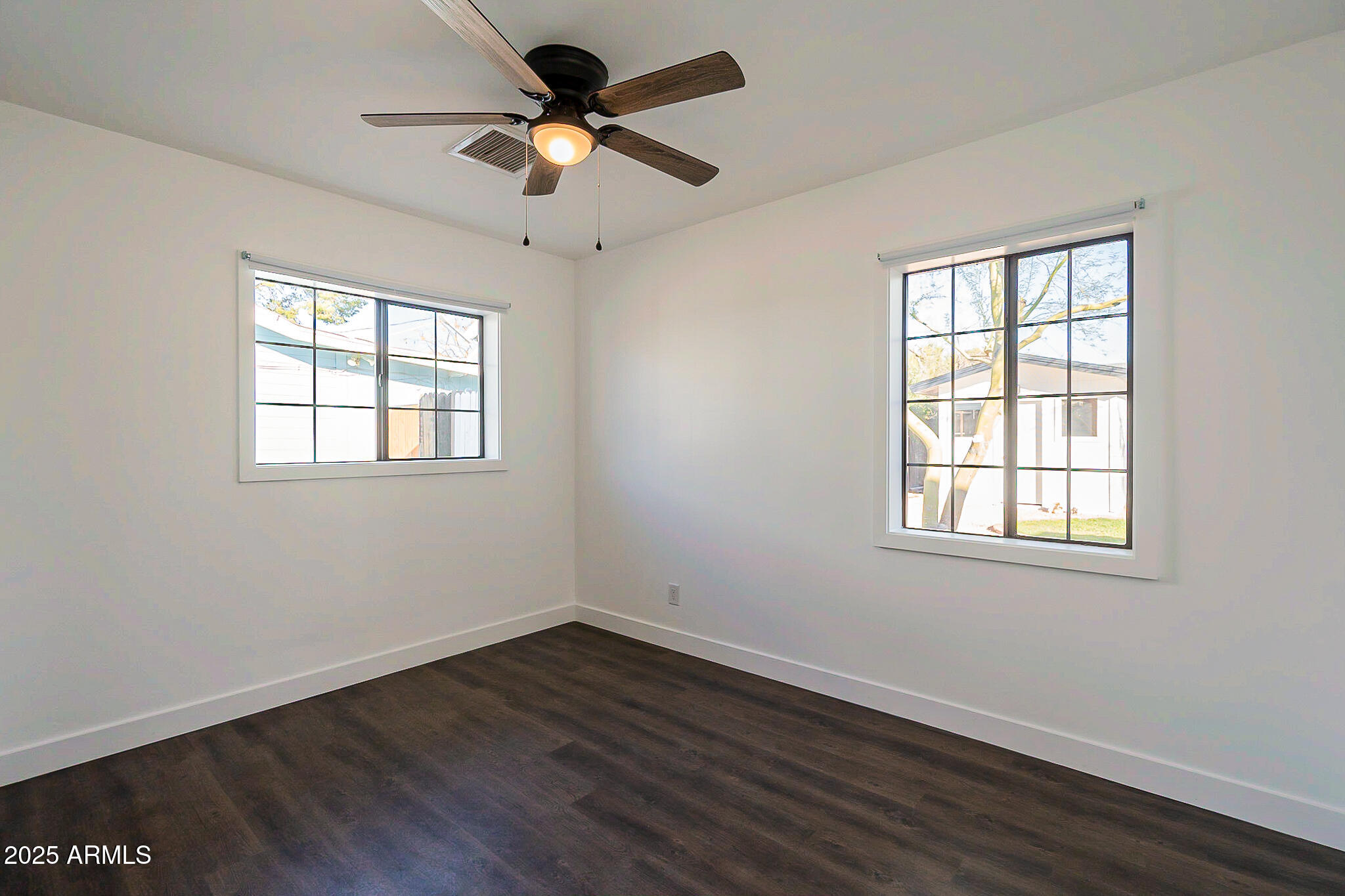 1316 East Lemon Street Tempe, AZ 85281 - Photo 27 of 43 a view of an empty room with wooden floor and a window