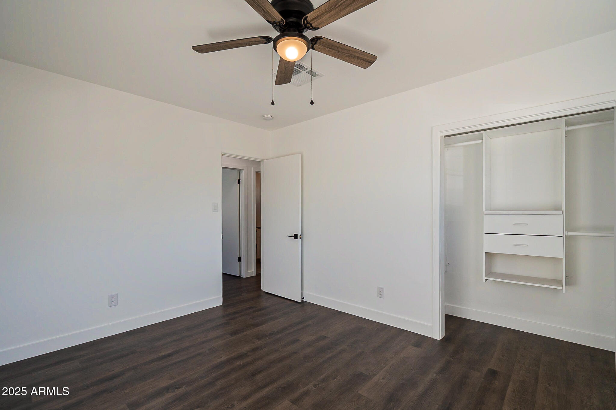 1316 East Lemon Street Tempe, AZ 85281 - Photo 30 of 43 an empty room with wooden floor closet ceiling fan and windows