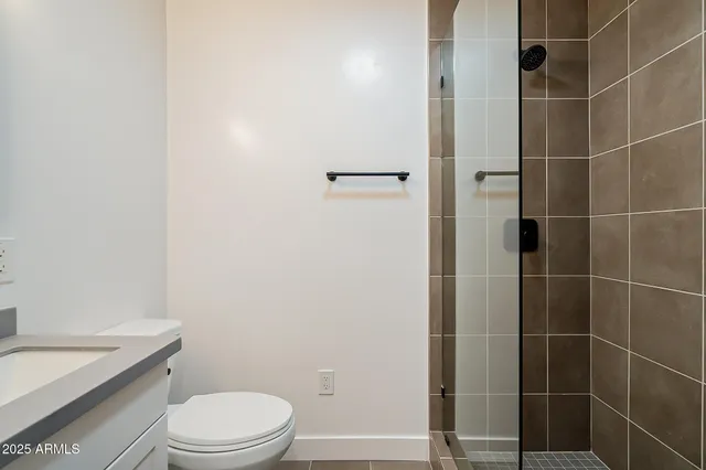 a white toilet sitting next to a bathroom sink