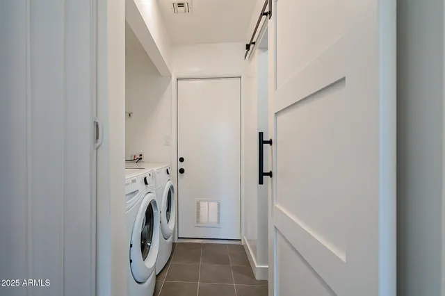 a view of bathroom with washer and dryer