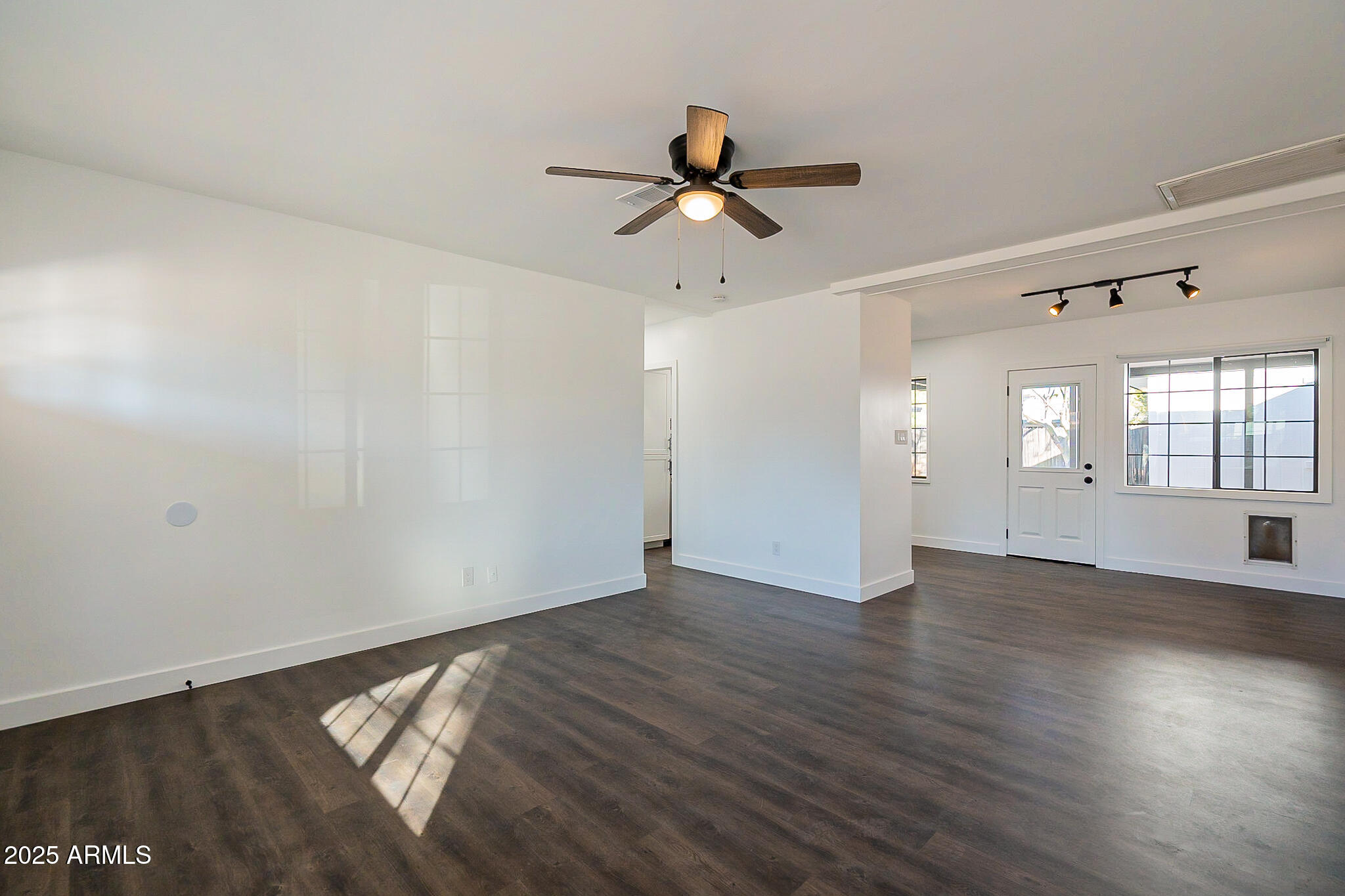 1316 East Lemon Street Tempe, AZ 85281 - Photo 6 of 43 a view of an empty room with wooden floor and a window