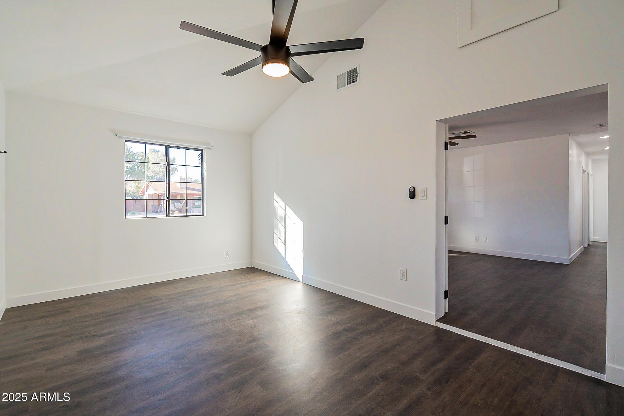1316 East Lemon Street Tempe, AZ 85281 - Photo 8 of 43 an empty room with wooden floor fan and windows