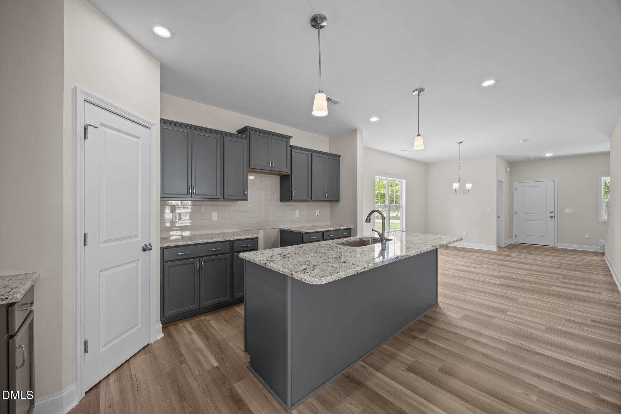 205 Regis Lane, Unit 11 Coats, NC 27521 - Photo 13 of 37 a kitchen with kitchen island a sink stainless steel appliances and cabinets