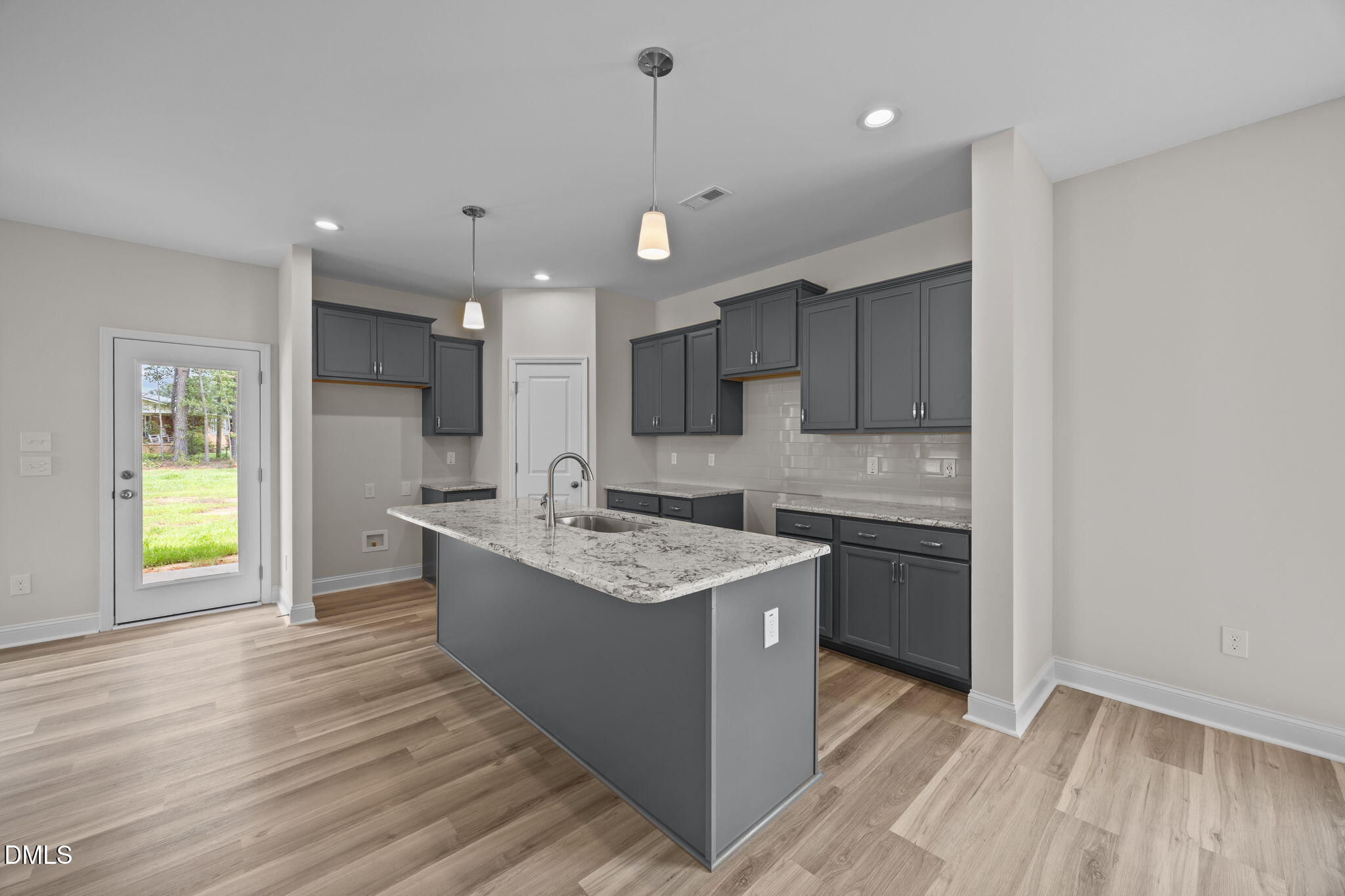 205 Regis Lane, Unit 11 Coats, NC 27521 - Photo 14 of 37 a kitchen with a sink appliances and cabinets