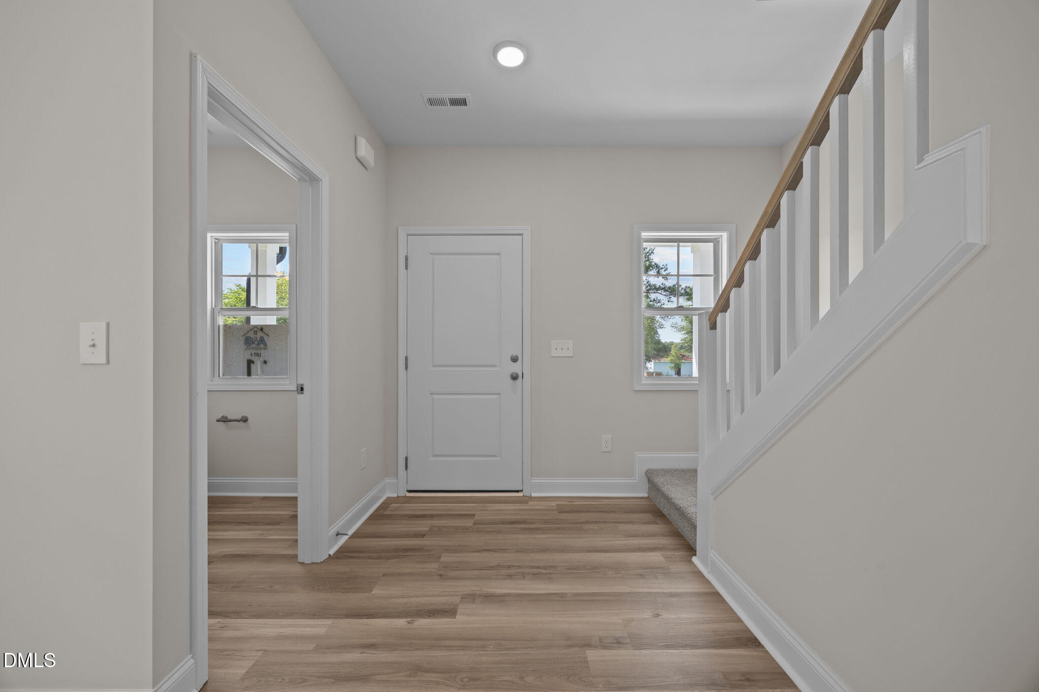 205 Regis Lane, Unit 11 Coats, NC 27521 - Photo 16 of 37 a view of a hallway with wooden floor and entryway
