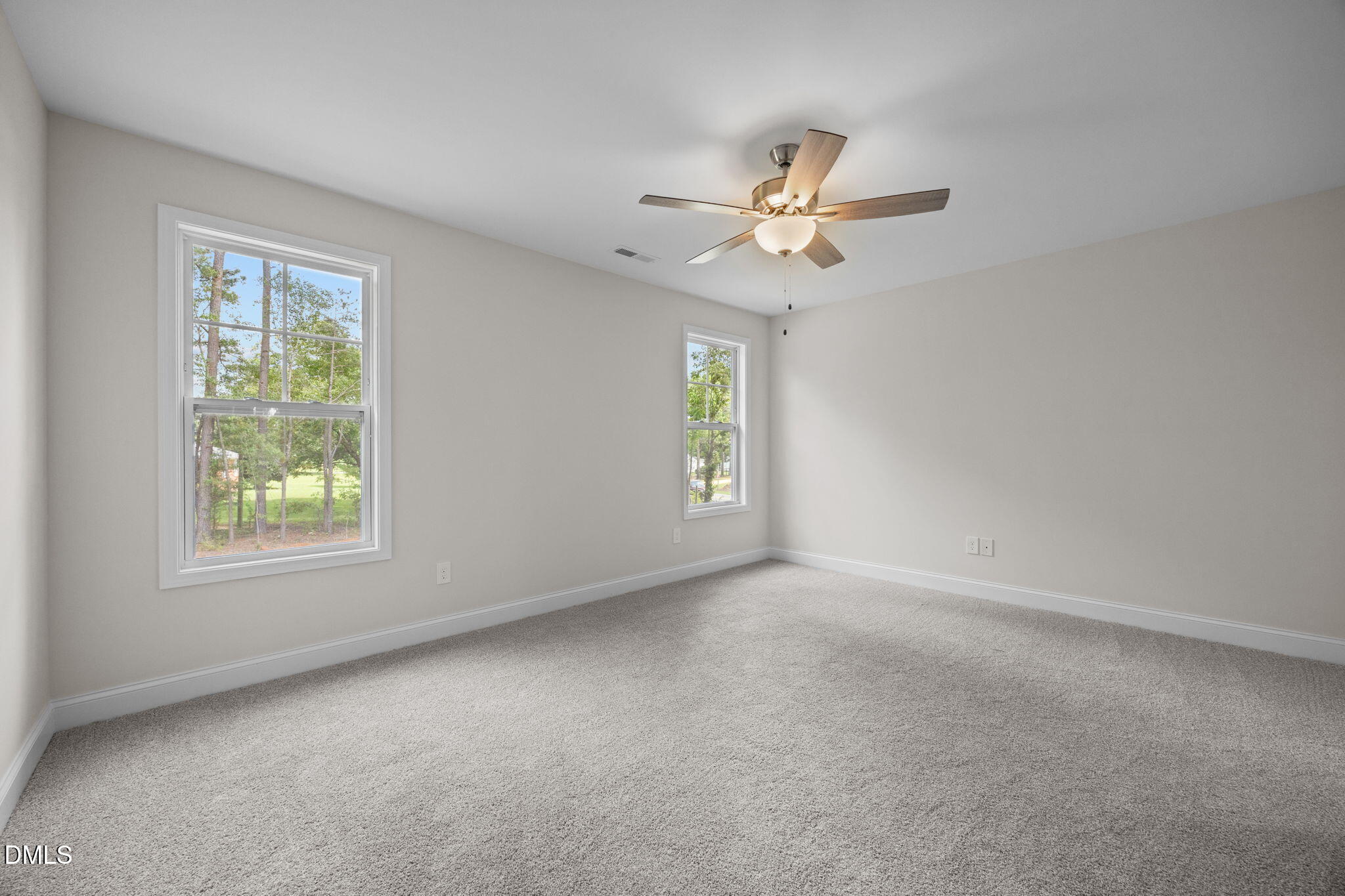 205 Regis Lane, Unit 11 Coats, NC 27521 - Photo 19 of 37 an empty room with windows and fan
