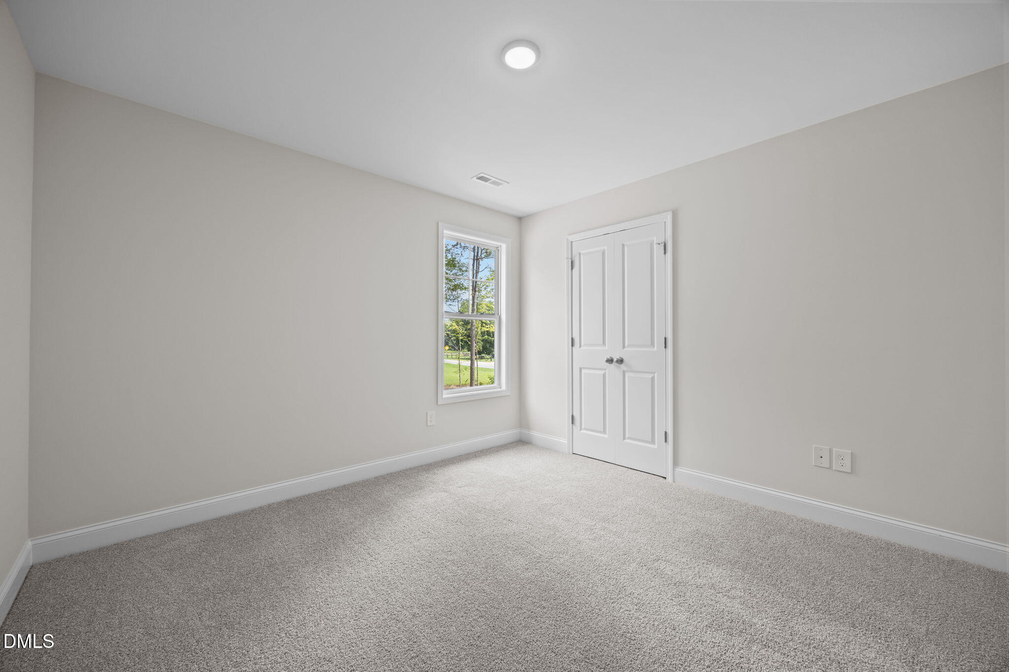 205 Regis Lane, Unit 11 Coats, NC 27521 - Photo 29 of 37 an empty room with windows and closet