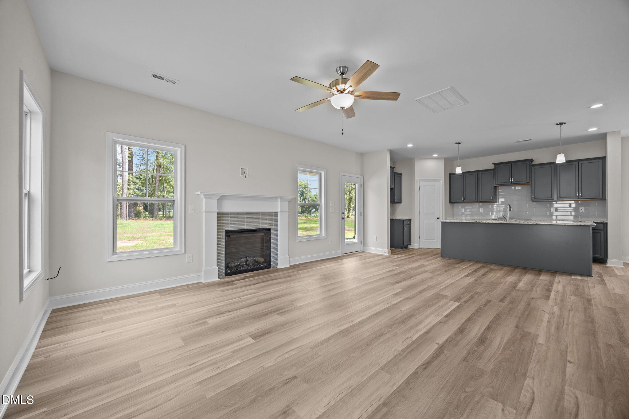 205 Regis Lane, Unit 11 Coats, NC 27521 - Photo 3 of 37 a view of an empty room with a kitchen and a window