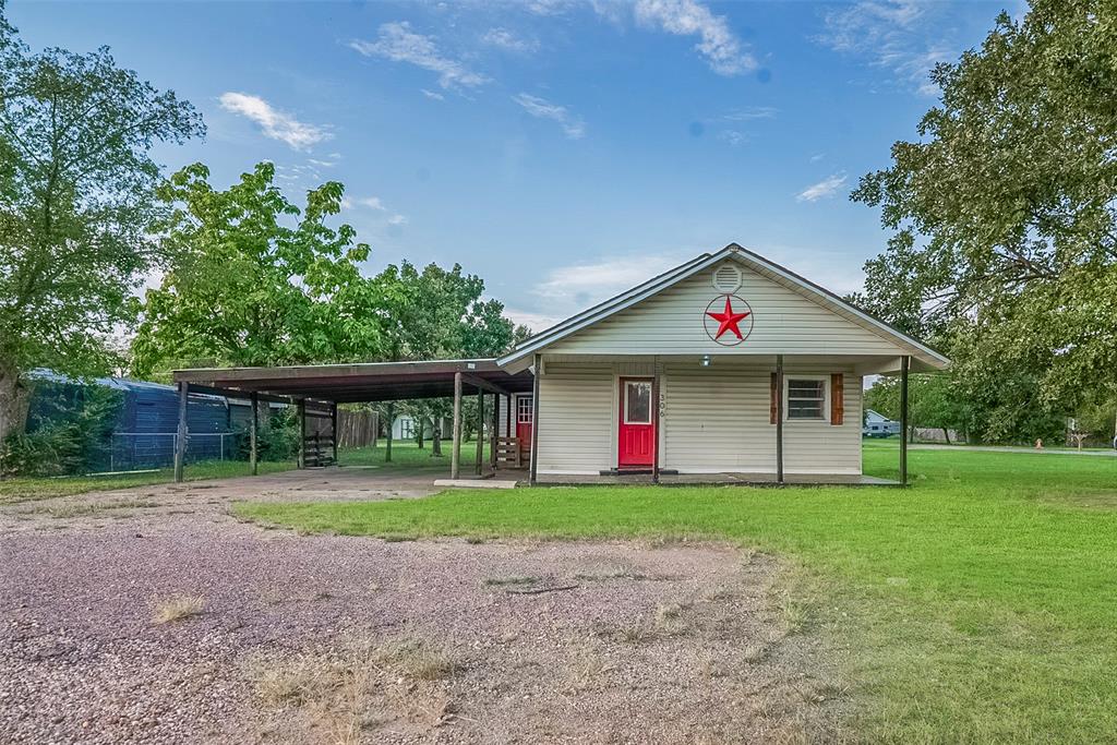 306 North Front Street Savoy, TX 75479 - Photo 1 of 27 a front view of house with yard and green space