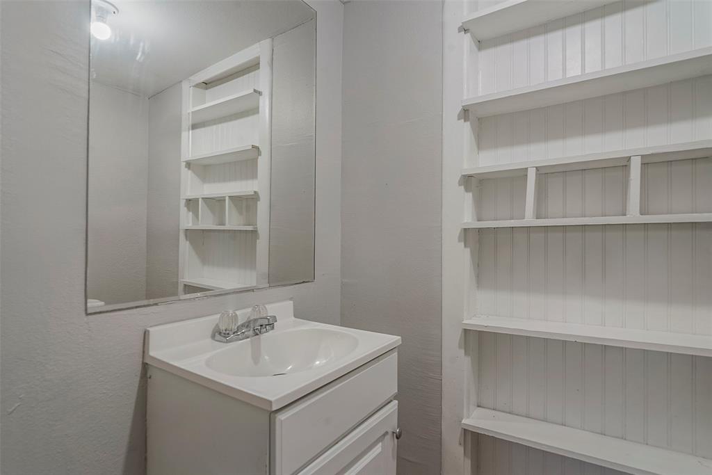306 North Front Street Savoy, TX 75479 - Photo 14 of 27 a bathroom with a sink and a mirror
