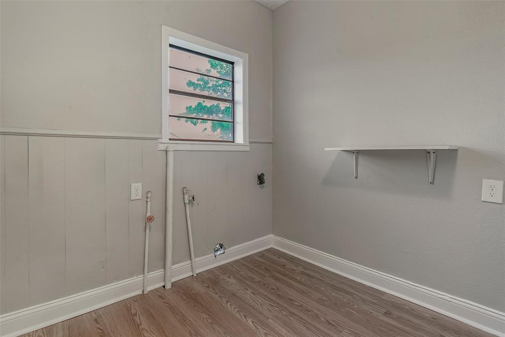 306 North Front Street Savoy, TX 75479 - Photo 19 of 27 a view of an empty room with wooden floor and a window