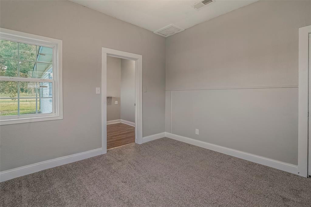 306 North Front Street Savoy, TX 75479 - Photo 25 of 27 an empty room with windows and closet